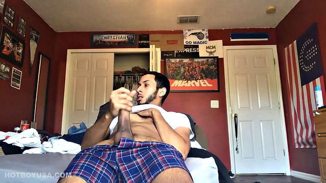 While watching a porn video, Brian kicks back, pushes his pants down and pulls his stiff dick out of the fly of his boxers. After a little stroking he pushes the underwear down to release his balls.