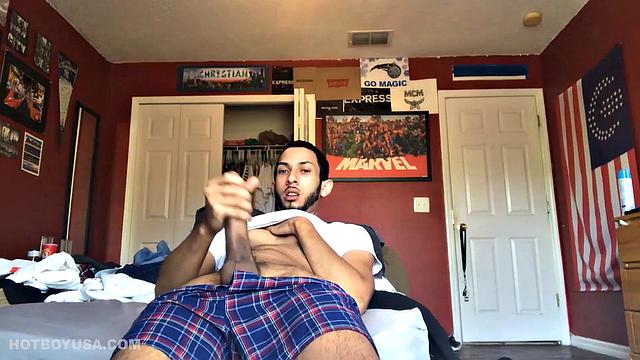 While watching a porn video, Brian kicks back, pushes his pants down and pulls his stiff dick out of the fly of his boxers. After a little stroking he pushes the underwear down to release his balls.