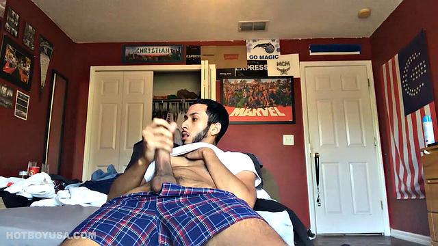 While watching a porn video, Brian kicks back, pushes his pants down and pulls his stiff dick out of the fly of his boxers. After a little stroking he pushes the underwear down to release his balls.