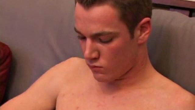 Brayden jerks off on the sofa while he watches a porn video, then scoots to the floor to suck on the head of his cock. After a good stroking, Brayden shoots his cum load on his tongue and face.