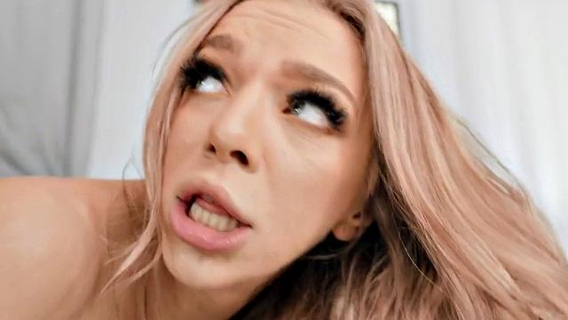 A blonde MILF with huge tits get her tiny pussy stuffed by a strapon while her client watches in the living room