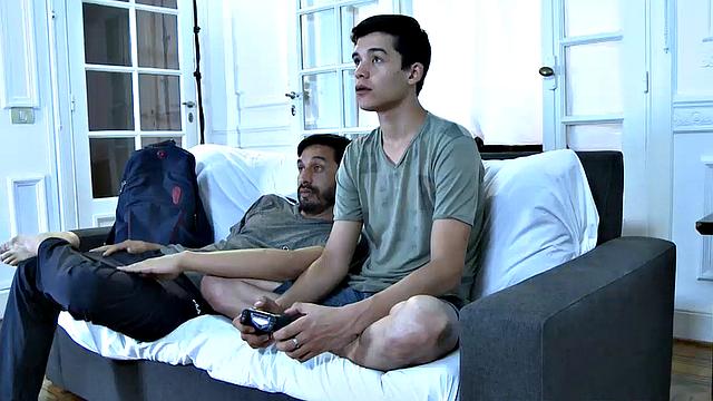 Cute young twink Joel is home playing video games while he waits for his sexy daddy to get home. Mitch arrives and oh boy is he horny.