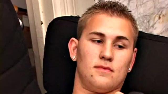 Adrian Knutts strips naked and works the remote control as he strokes his cock to the porn video.