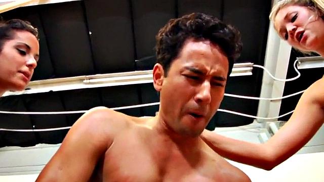 Femdoms in locker room peg sub's ass during group pegging