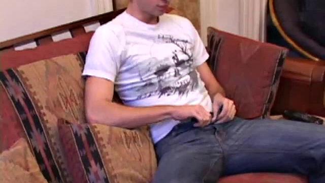 While watching a porn video, Gabriel Turner gets himself hard and then lubes his stiff dick for self-pleasuring.