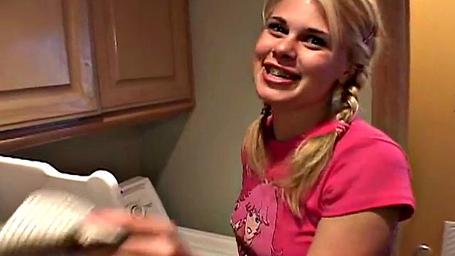 Blonde teen with small tits gets fingered in the laundry room while wearing a t-shirt and a pigtail