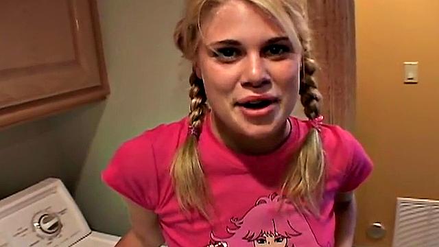 Blonde teen with small tits gets fingered in the laundry room while wearing a t-shirt and a pigtail