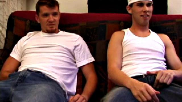 Lic seems very much at ease with Tapher. Both guys are in jeans and t-shirts, but lose them as they settle into each other. First, Lic slides his hand down his pants to work up a stiff one, while Tapher rubs one up from the outside.