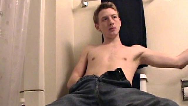 Sitting on the toilet, shirtless Corbin works his cock inside his pants. Then he tugs down his jeans and boxers before he's fully hard, which gives us the pleasure of watching him lube up and grow a stiffy.
