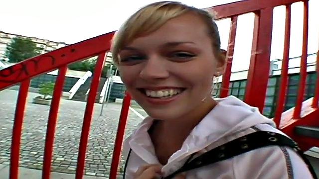 Watch this blonde hottie in a tight skinny top suck and lick a big dong outdoors