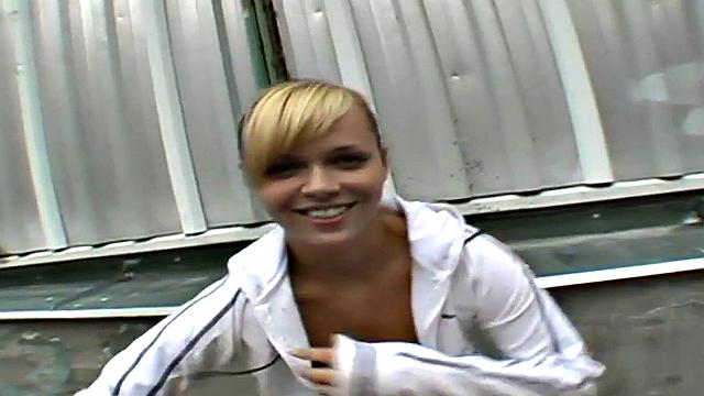 Watch this blonde hottie in a tight skinny top suck and lick a big dong outdoors