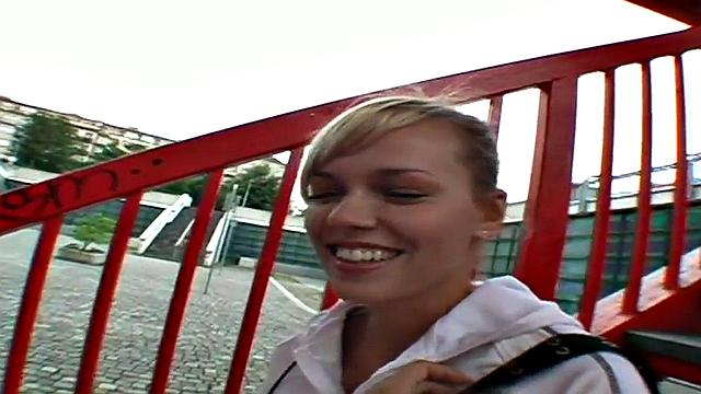 Watch this blonde hottie in a tight skinny top suck and lick a big dong outdoors