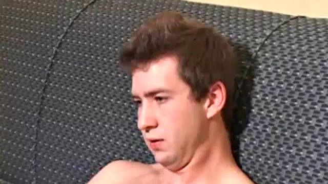 Donovan Woodside works up his boner on sofa with serious stroking and ass play, ending in warm cum