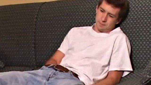 Donovan Woodside works up his boner on sofa with serious stroking and ass play, ending in warm cum