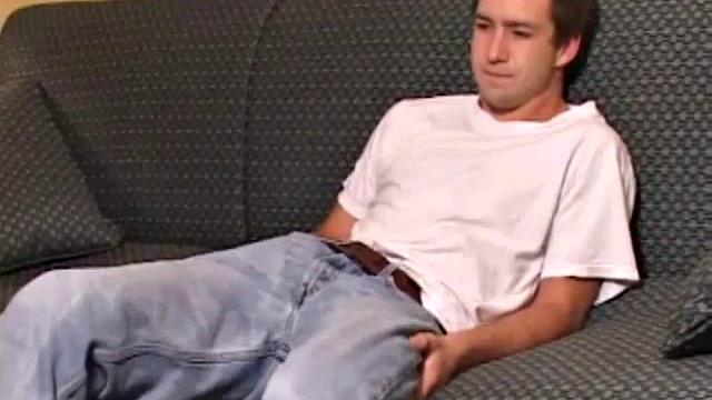 Donovan Woodside works up his boner on sofa with serious stroking and ass play, ending in warm cum