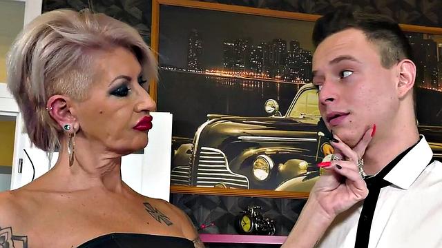 A tattooed mature slut take a hard pounding in doggystyle while wearing her dress and heels