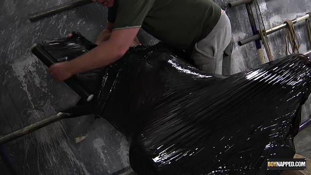 Chris Jansen and Sebastian Kane explore bondage with plastic wrap in a gay scene