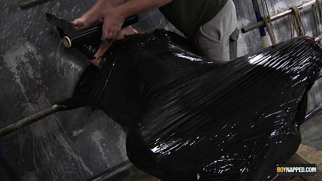 Chris Jansen and Sebastian Kane explore bondage with plastic wrap in a gay scene