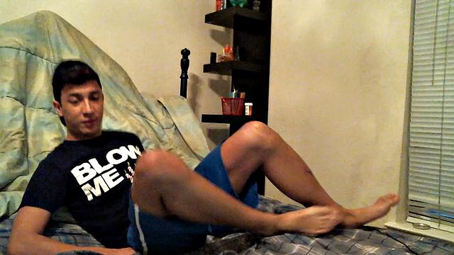 Latino boy Alexio Duran pulls off his shorts and strokes that big cock, rolling around on his bed.