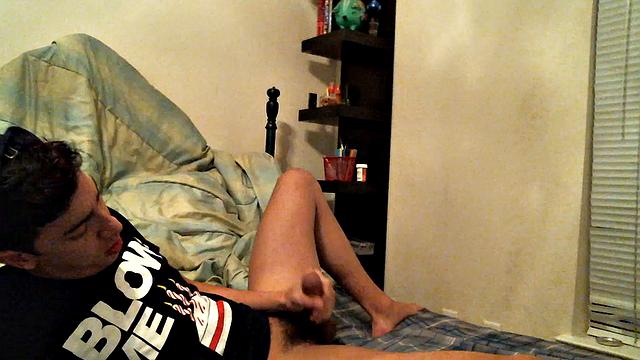 Latino boy Alexio Duran pulls off his shorts and strokes that big cock, rolling around on his bed.