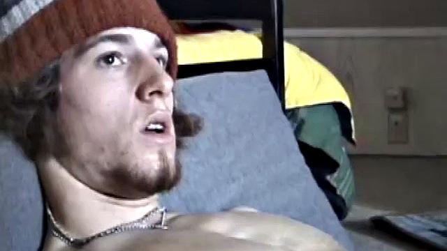 Adam relaxes on the floor watching porn video, strokes cock, plays with butthole, and blasts cum load onto skateboard