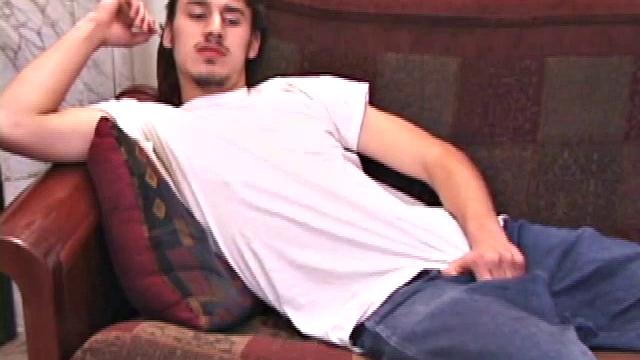 On a sofa, young Ricky Underton rubs himself through baggy jeans.