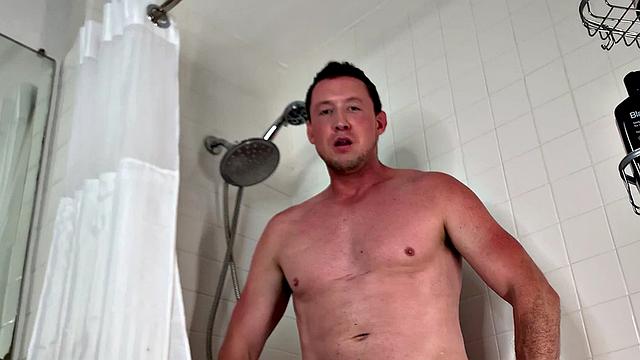 Soapy gay man jerks his hard cock in close bathtub scene