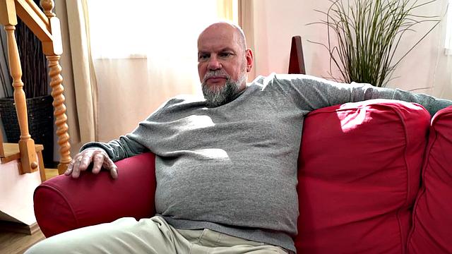 Redhead riding older guy in erotic couple on the couch