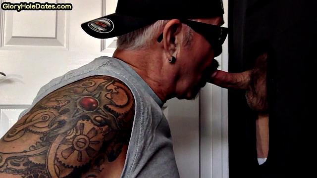 Tattooed DILF sucks gloryhole penis with his jizzed mouth