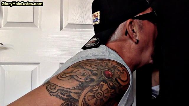 Tattooed DILF sucks gloryhole penis with his jizzed mouth