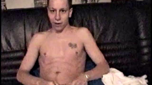 Kicking back on the couch, Dominic mugs a bit for the camera, as he flips through some porn mags for a little inspiration. He's pretty chatty at first, but gets quieter as he admires his hard dick and gets busy stroking it.