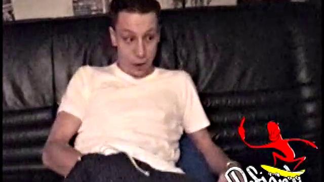 Kicking back on the couch, Dominic mugs a bit for the camera, as he flips through some porn mags for a little inspiration. He's pretty chatty at first, but gets quieter as he admires his hard dick and gets busy stroking it.