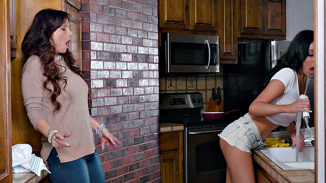 A hot brunette with big tits and tattoos get intimate in the living room with her man's new girlfriend