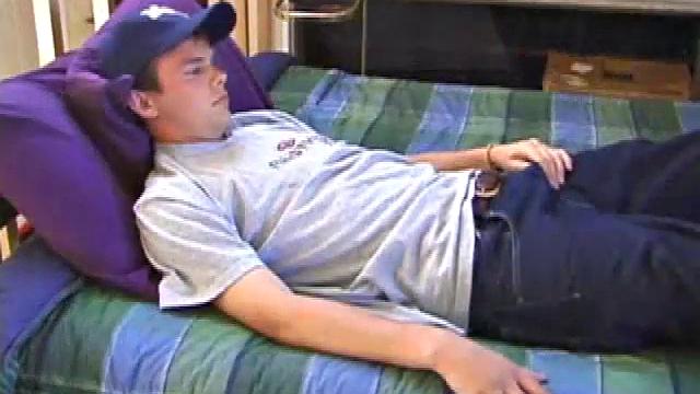 Sweet young Connor comes ready to jerk off. He lies down, sticks his hands in his pants and works up a stiffy. Soon his mushroom head cock bursts forth its cum load, all over his stomach.