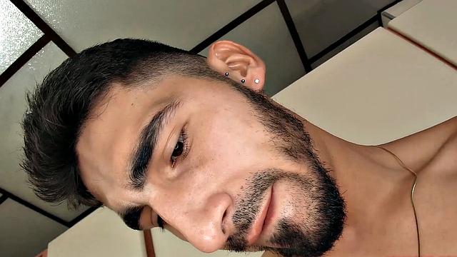 We find Julian in the kitchen, as his clothes slowly hit the floor. He pushes his pants and underwear down and a big boner pops out. Once Julian is completely naked, he leans against a counter and starts jacking off.