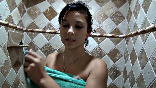 Watch Little Bailey Fingering her shaved pussy in the shower with a close-up view of her small tits and tattooed body