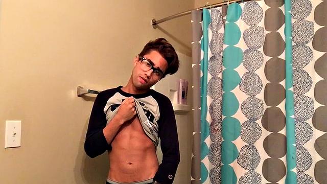 Skinny and smooth twink Gerald is in the bathroom to jerk off, and by the time this boy is naked he's sporting a monster uncut boner