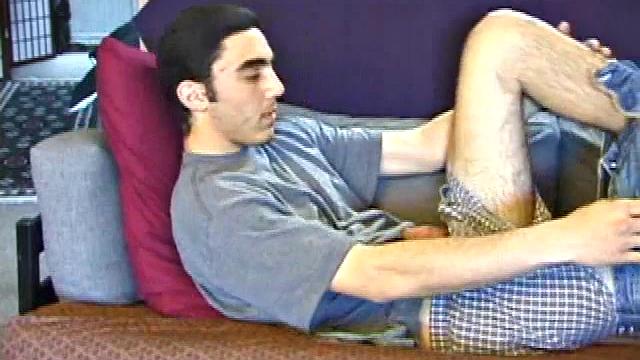 After a close-up of jeans being unzipped, Karod kicks back on the sofa and rubs a growing bulge through his boxers. If his complexion is less than perfect, his lean torso, hairy legs and thick happy trail more than compensate.