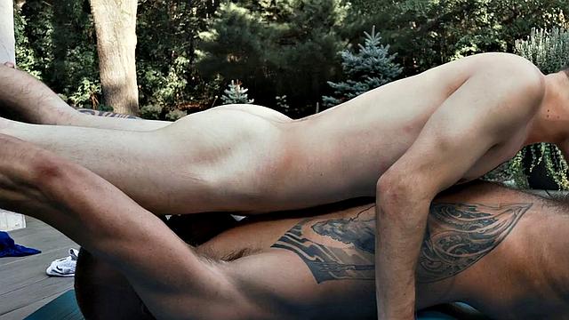Tiny twink rides athletic inked hunk outdoors