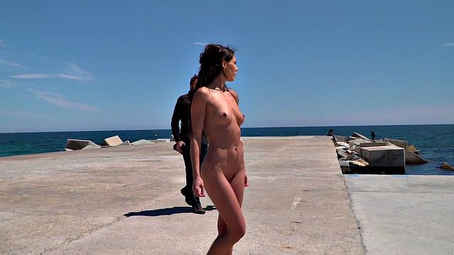 Perky attractive babe walks outdoors naked on the beach