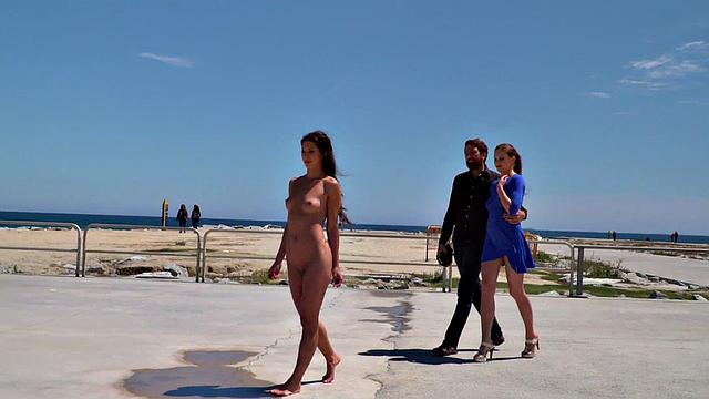 Perky attractive babe walks outdoors naked on the beach