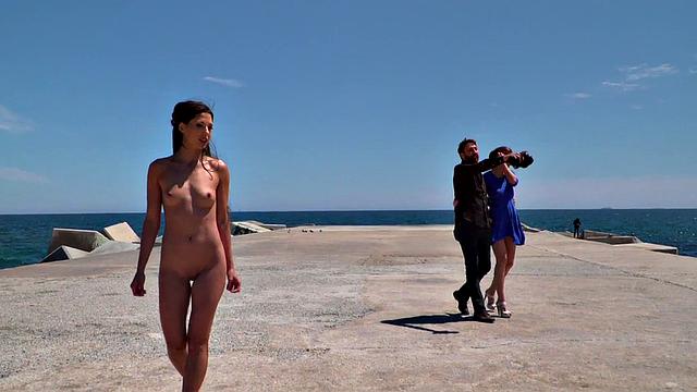 Perky attractive babe walks outdoors naked on the beach