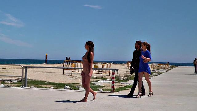 Perky attractive babe walks outdoors naked on the beach