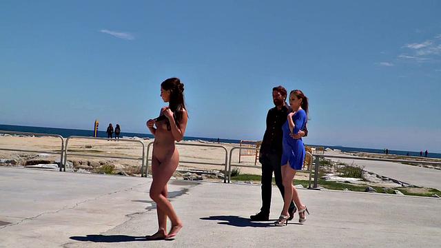 Perky attractive babe walks outdoors naked on the beach