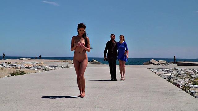 Perky attractive babe walks outdoors naked on the beach