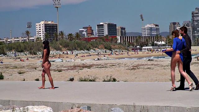 Perky attractive babe walks outdoors naked on the beach