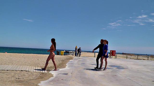 Perky attractive babe walks outdoors naked on the beach