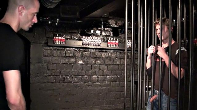 Bottom fucked in gay club by top from cage