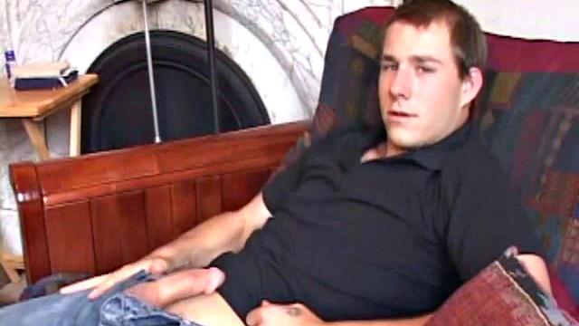 As the porn plays on the TV, Cory Woodall tugs on his cock. After pulling off his clothes, a helping hand begins to work his dick.