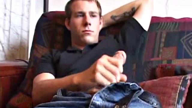 As the porn plays on the TV, Cory Woodall tugs on his cock. After pulling off his clothes, a helping hand begins to work his dick.